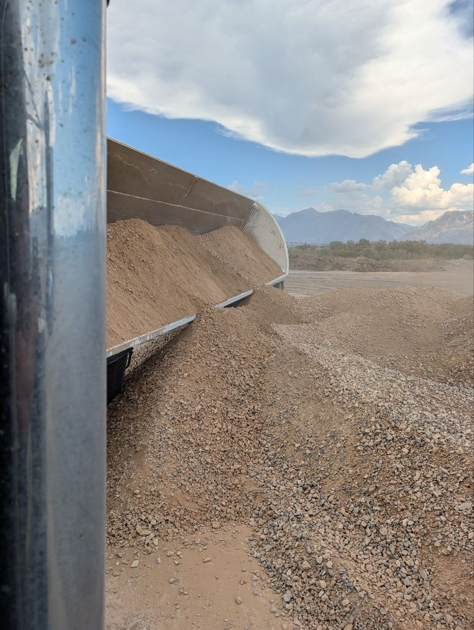 Side dump trailer unloading A1A engineered fill for a Saratoga Springs, Utah project